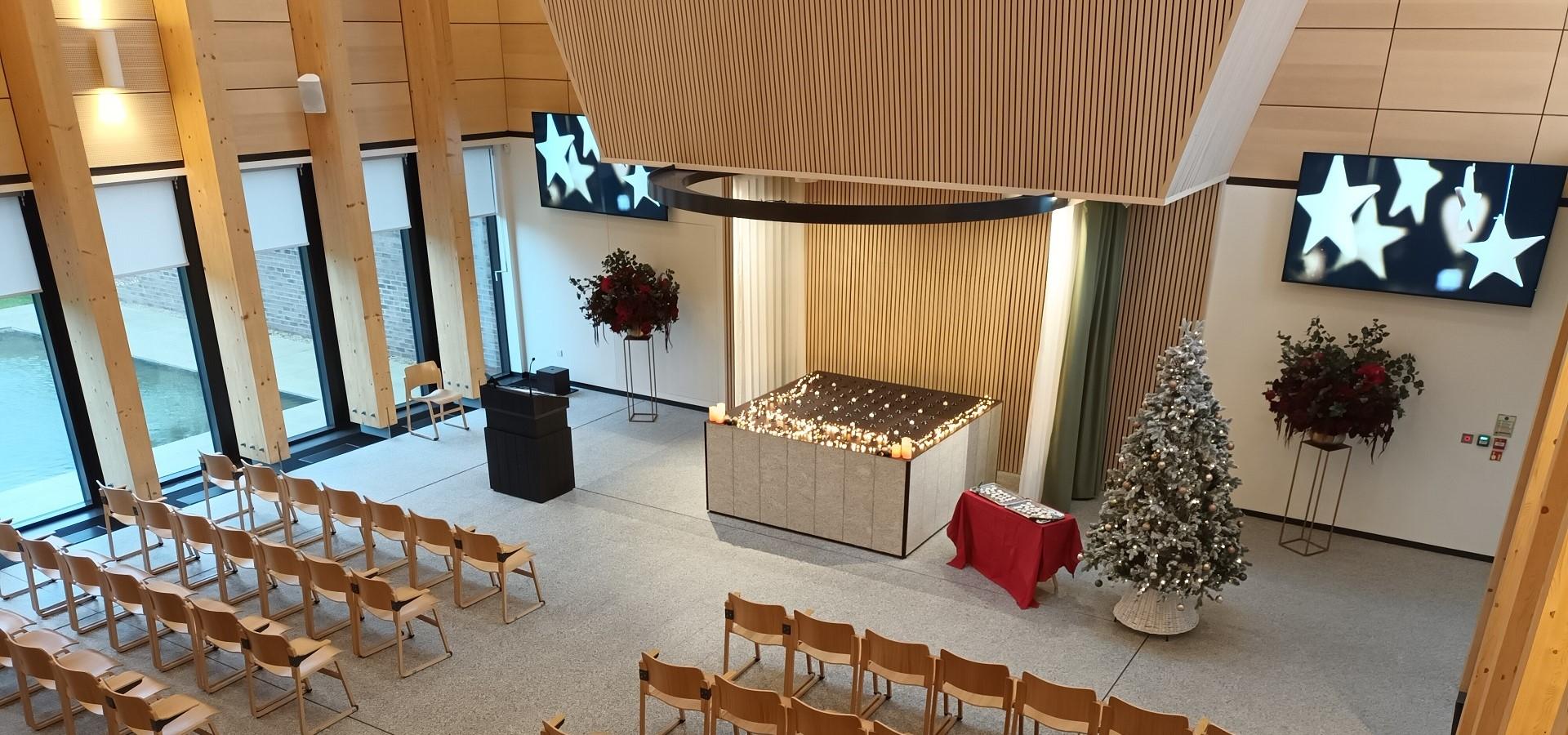 inside of the chapel with a christmas tree on display