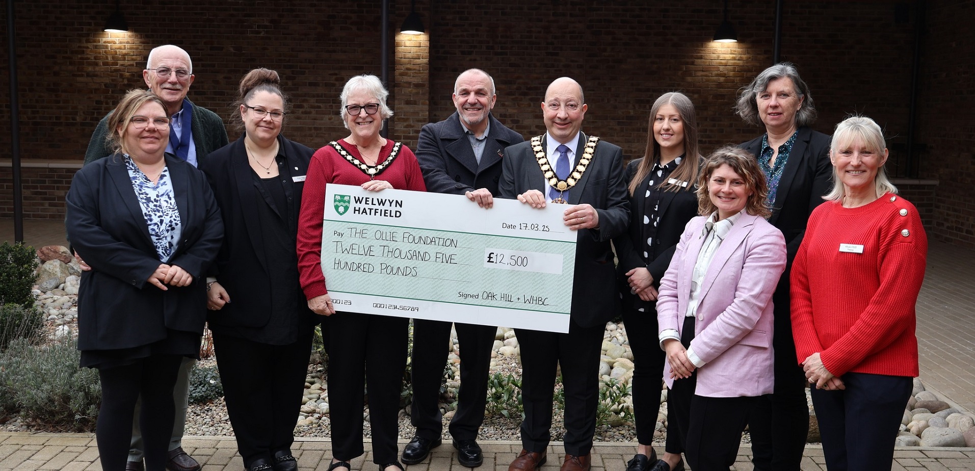 People holding large cheque for £12,500