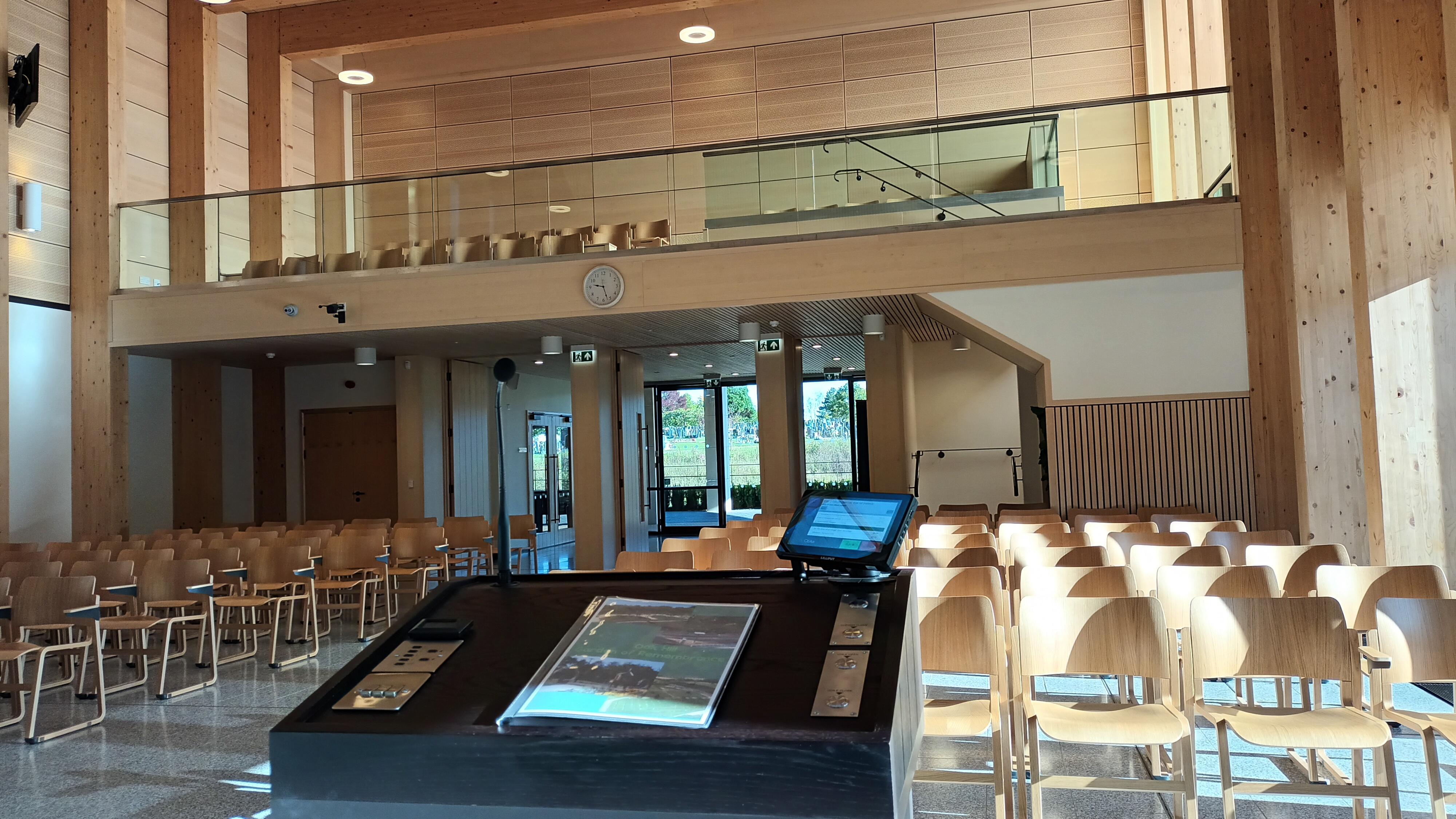 Inside of Oak Hills Chapel where there is a podium and various chairs behind it